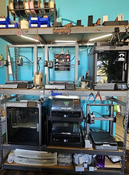 5 3d Printers on a metal storage rack for production printing
